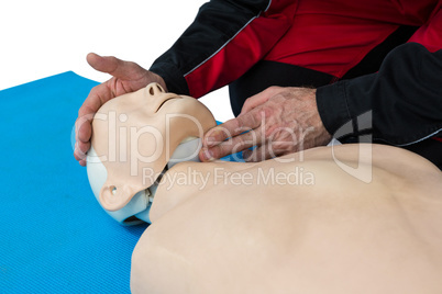 Paramedic practicing resuscitation on dummy