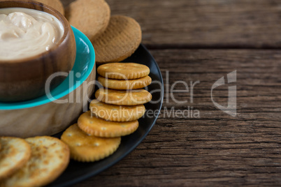 Cheese sauce with biscuits in black plate
