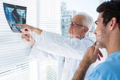 Surgeon and doctor discussing x-ray report