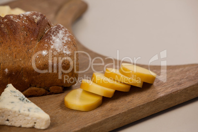 Cheese and bread on chopping board