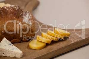 Cheese and bread on chopping board