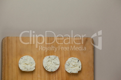 Slices of cheese on chopping board