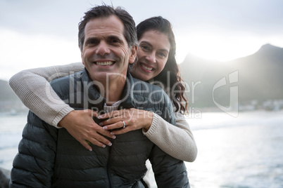 Portrait of romantic couple embracing each other on beach