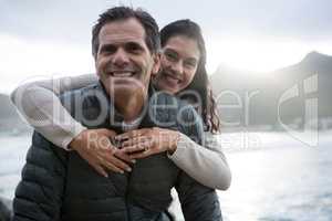 Portrait of romantic couple embracing each other on beach