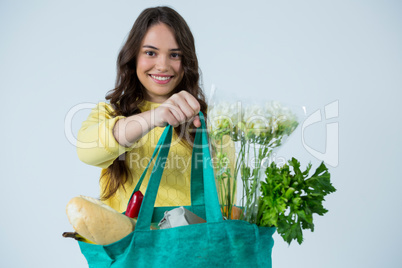 Beautiful woman carrying grocery bag