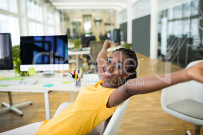 Female business executive with arms outstretched