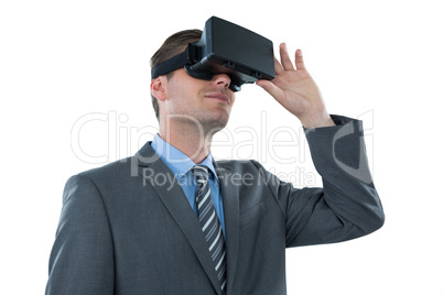 Businessman using virtual reality headset against white background