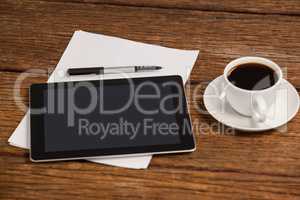 Digital tablet and cup of coffee