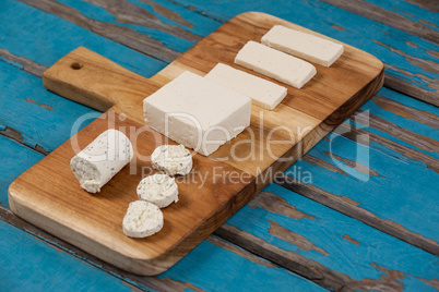 Variety of cheese arranged on chopping board