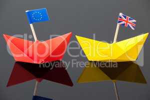 Two paper boats with union jack and european union flag