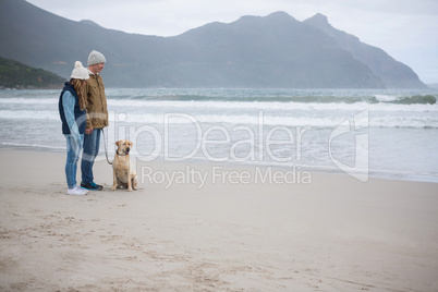 Couple standing with their pet dog