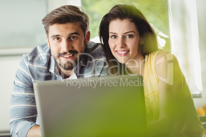 Happy couple using laptop