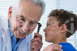 Doctor and patient using otoscope