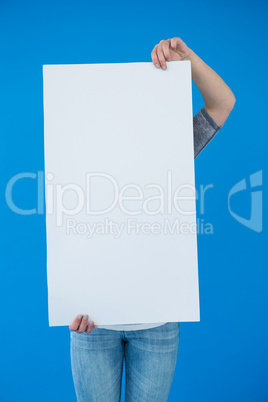 Woman holding a blank placard in front of her face