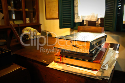 Classic office room with books on the desk.