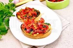 Bruschetta with tomatoes and peppers in plate on granite table