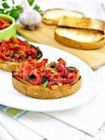 Bruschetta with tomatoes and peppers in plate on napkin