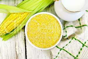 Corn grits in bowl on board top