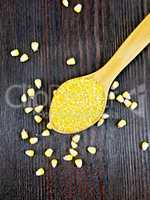 Corn grits in spoon on board top