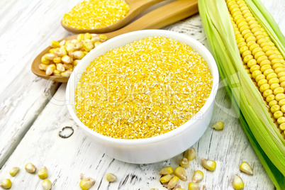 Corn grits in white bowl on light board