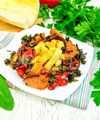 Courgettes with vegetables in plate on towel