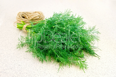 Dill with twine on granite table