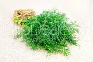 Dill with twine on granite table