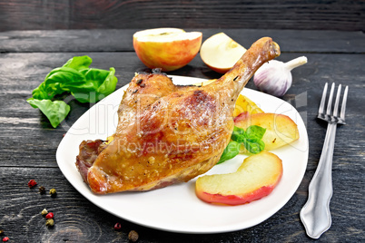 Duck leg with apple and basil on board