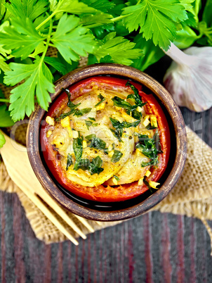 Fish baked with tomato in clay bowl on board top