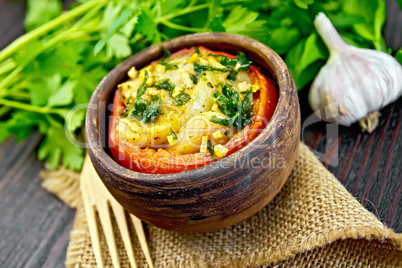Fish baked with tomato in clay bowl on board