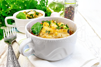 Fish baked with tomato in white bowl on napkin