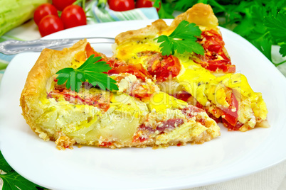 Flan with tomato and zucchini in plate on light board