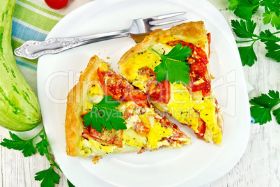 Flan with tomato and zucchini on light board top