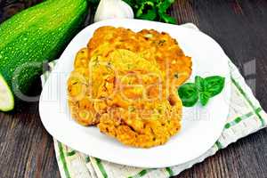 Flapjack chickpeas with zucchini in plate on dark board