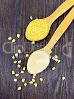 Flour and cereals corn in spoon on dark board top