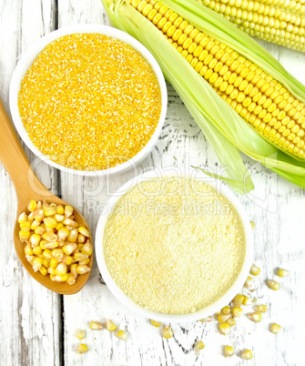 Flour and grits corn in bowls with grains on board top