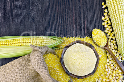 Flour and grits corn with bag on wooden board