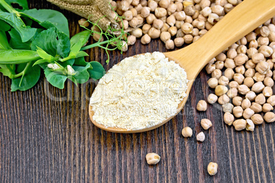 Flour chickpeas in spoonful with peas on board