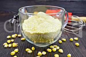 Flour corn in cup with grains on board