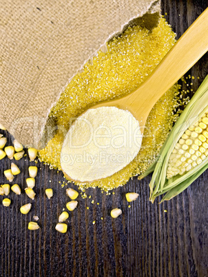Flour corn in spoon with grains on board top