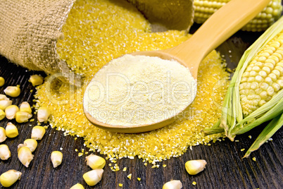 Flour corn in spoon with grains on board