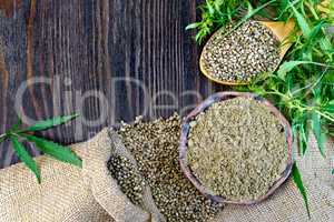 Flour hemp in bowl and seed in wooden spoon on board