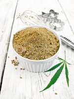 Flour hemp in bowl with leaf on board