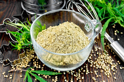 Flour hemp in glass cup with leaf on board