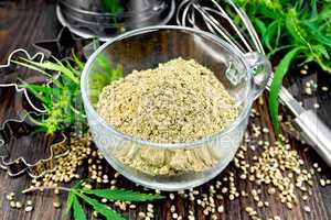 Flour hemp in glass cup with leaf on board