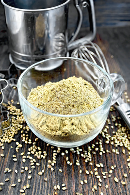 Flour hemp in glass cup with mixer on board