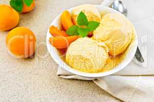 Ice cream apricot in white bowl on napkin