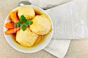 Ice cream apricot in white bowl on table top