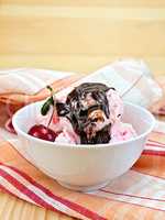 Ice cream cherry with chocolate syrup on board