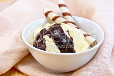 Ice cream vanilla with wafer rolls on napkin